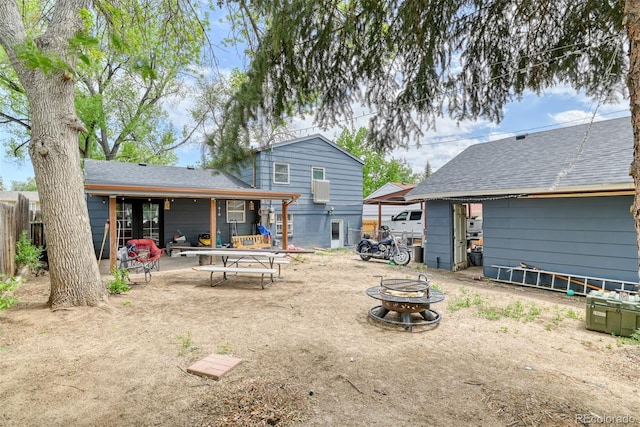 12 Arrawanna St, Colorado Springs, CO 80909 - back of house with an outdoor fire pit, a patio area, and roof with shingles