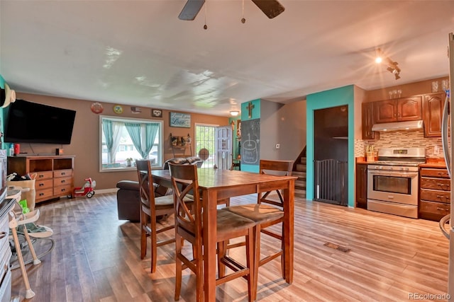 12 Arrawanna St, Colorado Springs, CO 80909 - dining area featuring light wood finished floors, stairway, baseboards, and ceiling fan