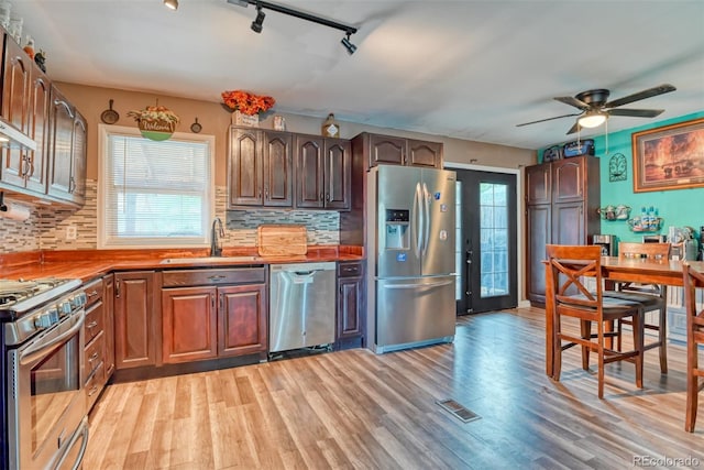 12 Arrawanna St, Colorado Springs, CO 80909 - kitchen with stainless steel appliances, a sink, track lighting, and light wood finished floors