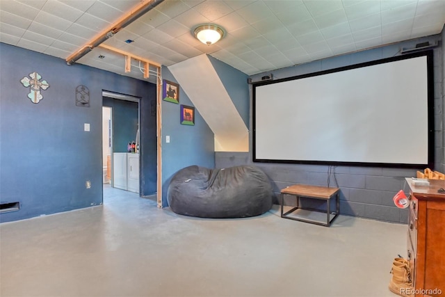12 Arrawanna St, Colorado Springs, CO 80909 - home theater room featuring washer and dryer and concrete flooring