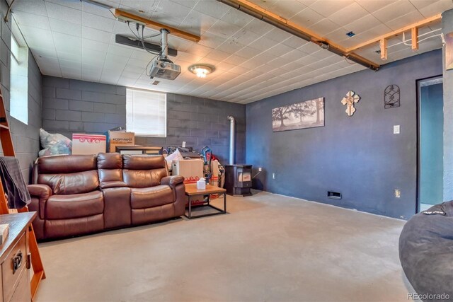 12 Arrawanna St, Colorado Springs, CO 80909 - cinema with a wood stove, concrete floors, and concrete block wall