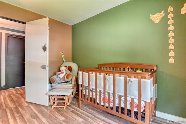 12 Arrawanna St, Colorado Springs, CO 80909 - bedroom with wood finished floors and a crib