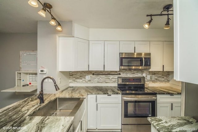 kitchen with sink, white cabinets, and appliances with stainless steel finishes