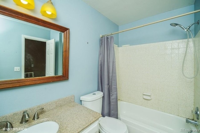 full bathroom with shower / bathtub combination with curtain, vanity, and toilet