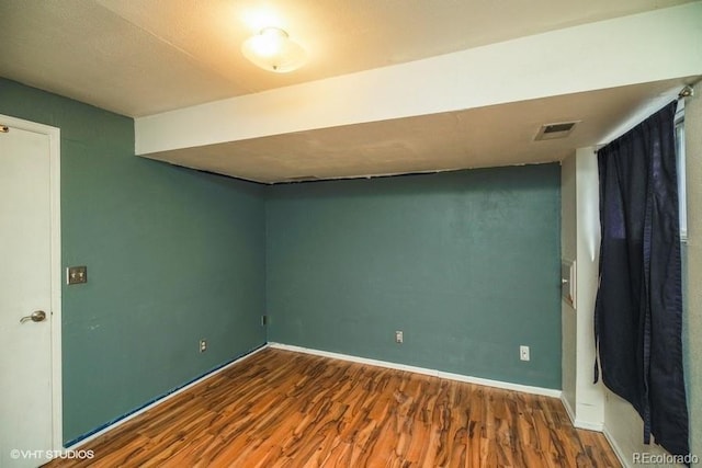 empty room with wood-type flooring