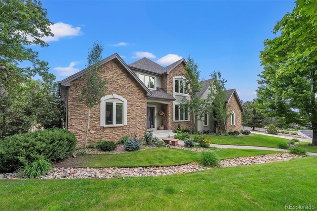 1999 Champions Cir, Castle Rock, CO 80104 - view of front facade featuring stone siding and a front yard