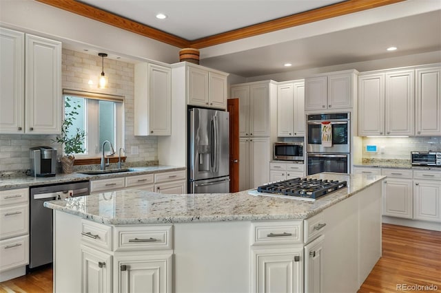 1999 Champions Cir, Castle Rock, CO 80104 - kitchen featuring stainless steel appliances, backsplash, a center island, white cabinets, and recessed lighting