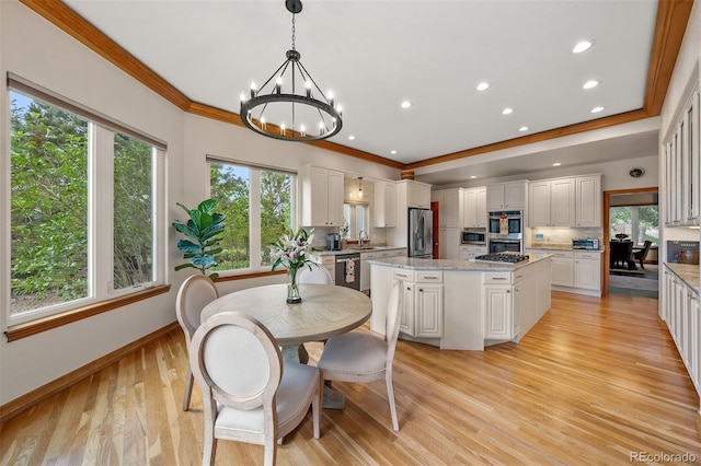 1999 Champions Cir, Castle Rock, CO 80104 - dining space featuring ornamental molding, plenty of natural light, a chandelier, light wood finished floors, and recessed lighting
