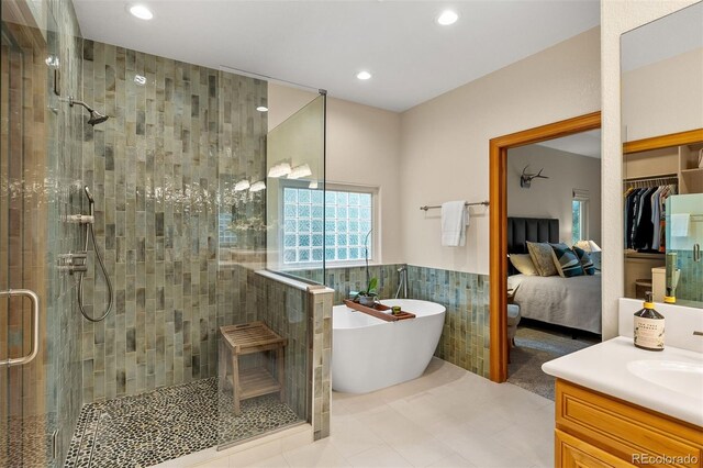 1999 Champions Cir, Castle Rock, CO 80104 - bathroom with a stall shower, tile walls, vanity, a freestanding tub, and recessed lighting