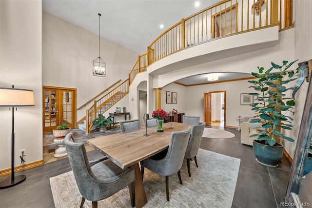 1999 Champions Cir, Castle Rock, CO 80104 - dining space with arched walkways, a high ceiling, stairway, and french doors