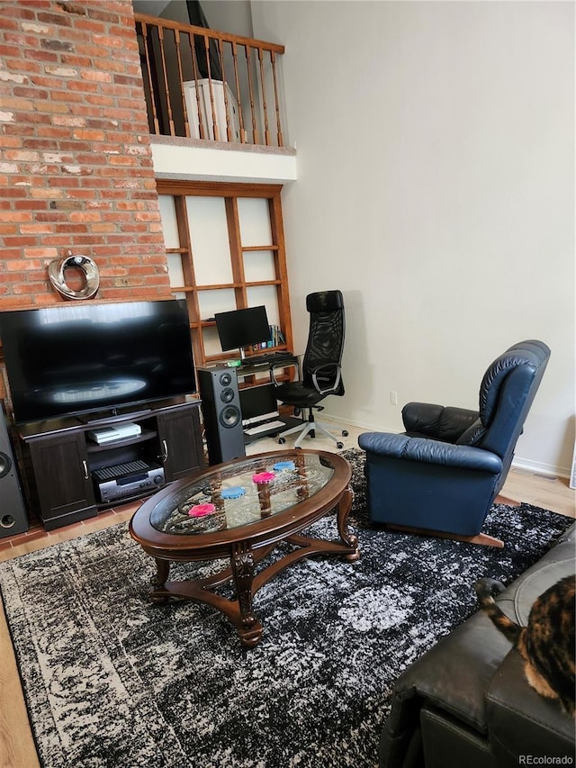 living area featuring a desk and baseboards