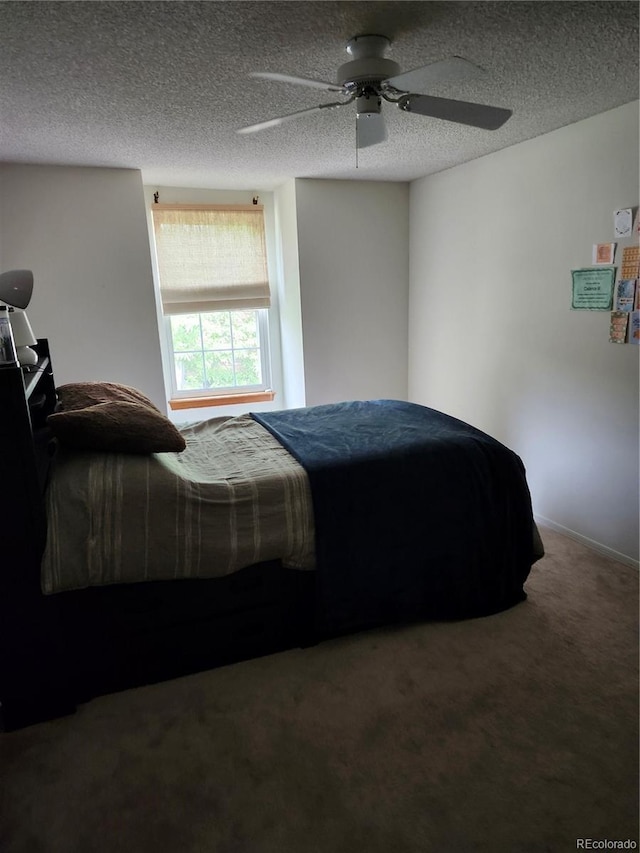 carpeted bedroom with a ceiling fan and a textured ceiling