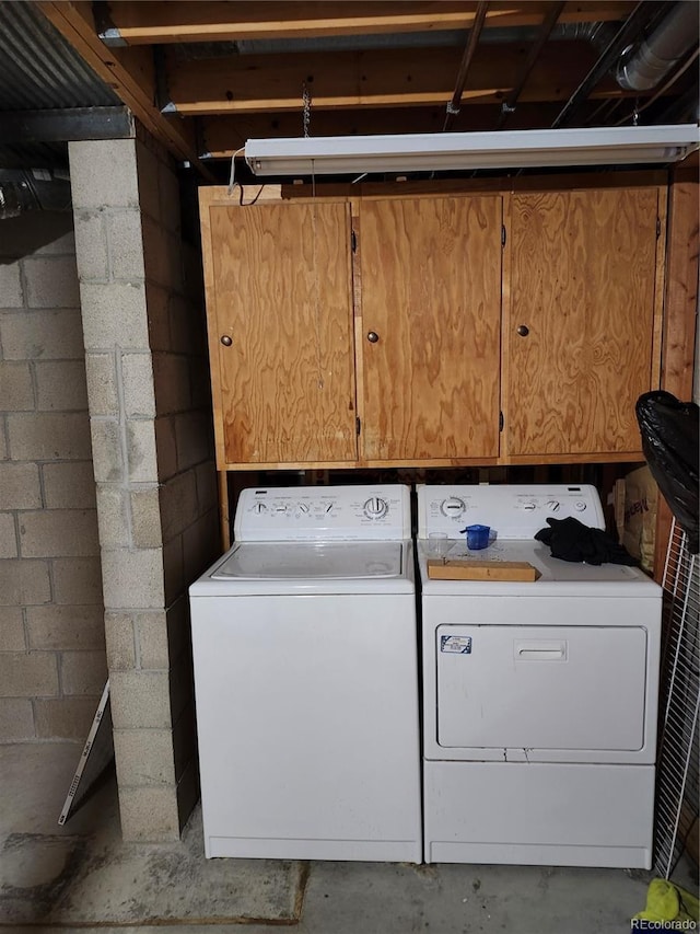 laundry area featuring independent washer and dryer and concrete block wall