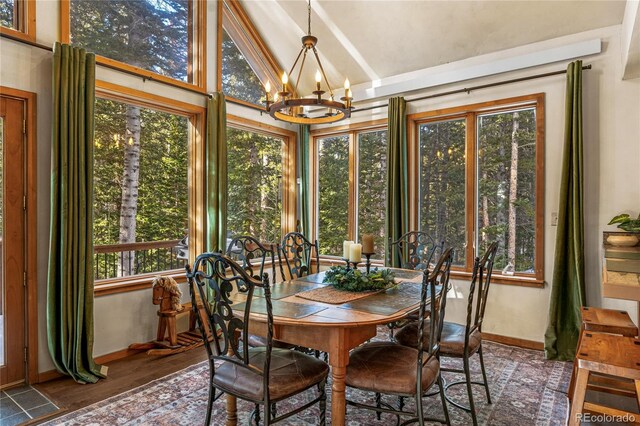 609 Brook Dr, Idaho Springs, CO 80452 - sunroom / solarium featuring a chandelier, lofted ceiling, baseboards, and wood finished floors