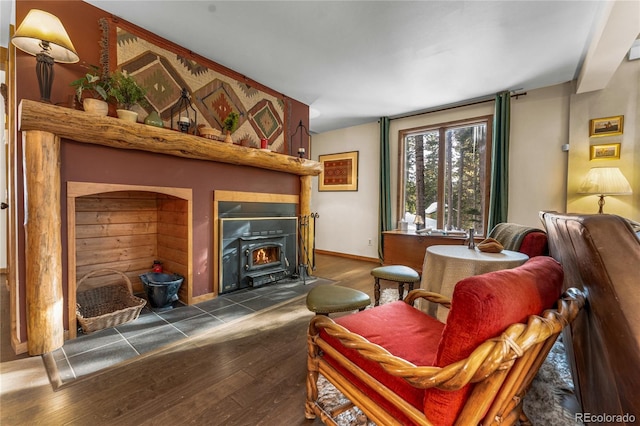 609 Brook Dr, Idaho Springs, CO 80452 - living room with dark wood-type flooring, a wood stove, and baseboards
