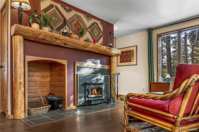 609 Brook Dr, Idaho Springs, CO 80452 - sitting room featuring wood finished floors, a lit fireplace, and arched walkways