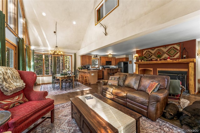 609 Brook Dr, Idaho Springs, CO 80452 - living room with high vaulted ceiling, dark wood-style flooring, a chandelier, and recessed lighting