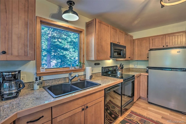 609 Brook Dr, Idaho Springs, CO 80452 - kitchen with black appliances, a sink, healthy amount of natural light, and light wood finished floors