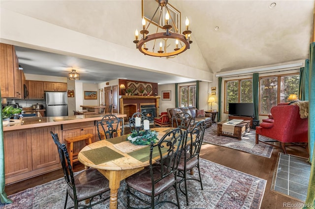 609 Brook Dr, Idaho Springs, CO 80452 - dining area with a chandelier, dark wood finished floors, and vaulted ceiling