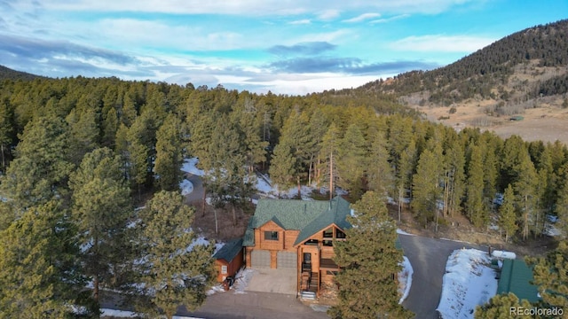 drone / aerial view with a mountain view and a forest view