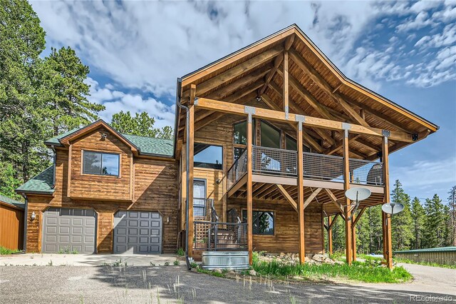 view of front of house featuring a garage and a balcony