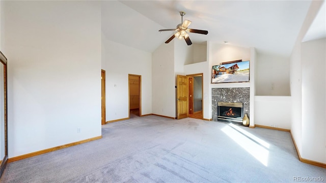 unfurnished living room featuring baseboards, a ceiling fan, a tiled fireplace, carpet flooring, and high vaulted ceiling