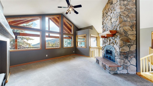 unfurnished living room featuring carpet floors, ceiling fan, a stone fireplace, high vaulted ceiling, and baseboards