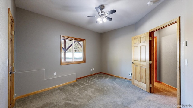 unfurnished bedroom featuring carpet, a ceiling fan, and baseboards