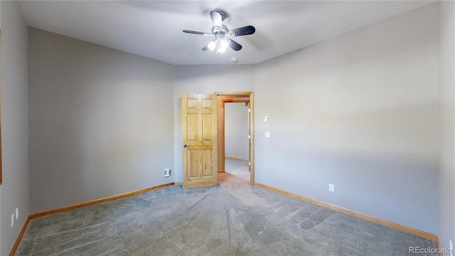 unfurnished room featuring a ceiling fan, baseboards, and carpet flooring