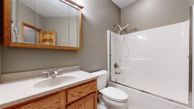 bathroom featuring tub / shower combination, vanity, and toilet