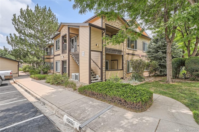 4875 S Balsam Way Unit 6-202, Littleton, CO 80123 - view of building exterior with uncovered parking and stairway