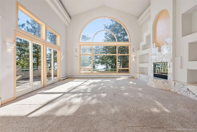 23655 Currant Dr, Golden, CO 80401 - unfurnished living room featuring high vaulted ceiling, carpet flooring, a glass covered fireplace, and built in features