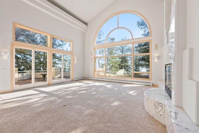 23655 Currant Dr, Golden, CO 80401 - unfurnished living room with high vaulted ceiling, carpet, and a baseboard radiator