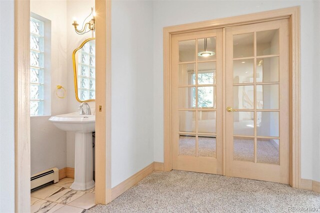 23655 Currant Dr, Golden, CO 80401 - bathroom featuring a baseboard heating unit, french doors, plenty of natural light, and a sink