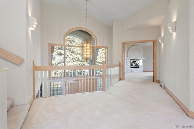 23655 Currant Dr, Golden, CO 80401 - corridor featuring carpet floors, a chandelier, vaulted ceiling, baseboards, and an upstairs landing
