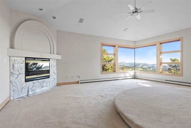 23655 Currant Dr, Golden, CO 80401 - unfurnished living room with carpet floors, lofted ceiling, a ceiling fan, a baseboard radiator, and baseboards