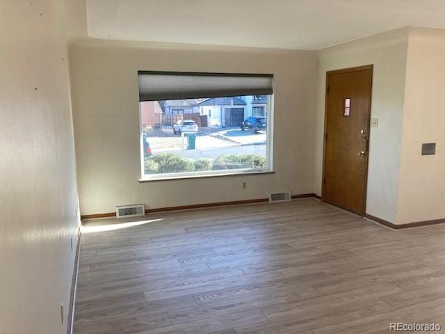 unfurnished room featuring light hardwood / wood-style floors