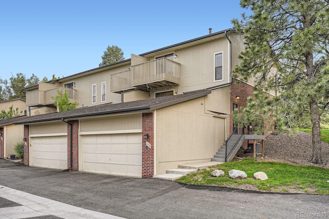 108 S Holman Way, Golden, CO 80401 - view of front of home with a balcony, community garages, and brick siding