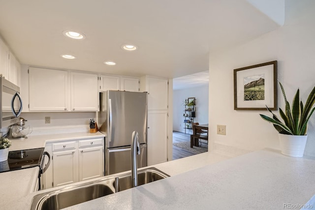 108 S Holman Way, Golden, CO 80401 - kitchen featuring appliances with stainless steel finishes, recessed lighting, white cabinets, and light countertops