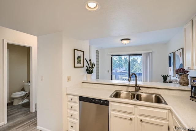 108 S Holman Way, Golden, CO 80401 - kitchen featuring dishwasher, light countertops, light wood finished floors, and white cabinets