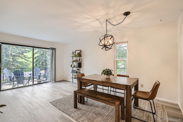 108 S Holman Way, Golden, CO 80401 - dining space featuring a chandelier, plenty of natural light, and light wood finished floors
