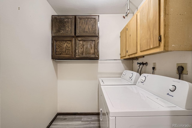108 S Holman Way, Golden, CO 80401 - laundry area featuring cabinet space, separate washer and dryer, and wood finished floors