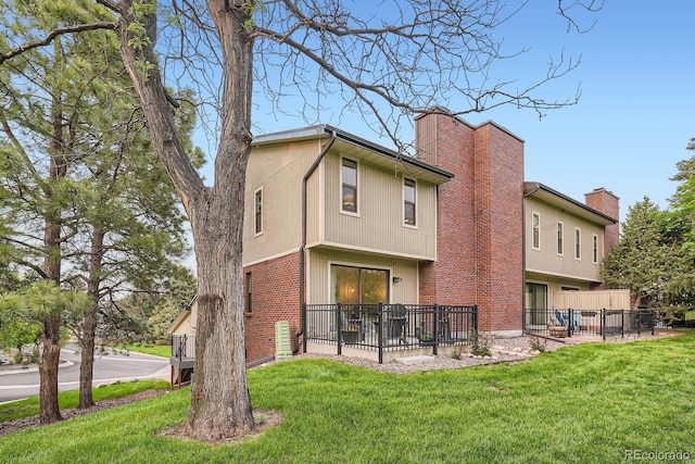 108 S Holman Way, Golden, CO 80401 - back of house featuring brick siding and a chimney