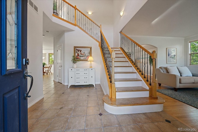 9375 Webster Way, Westminster, CO 80021 - tiled entrance foyer with healthy amount of natural light, baseboards, stairway, arched walkways, and ornamental molding