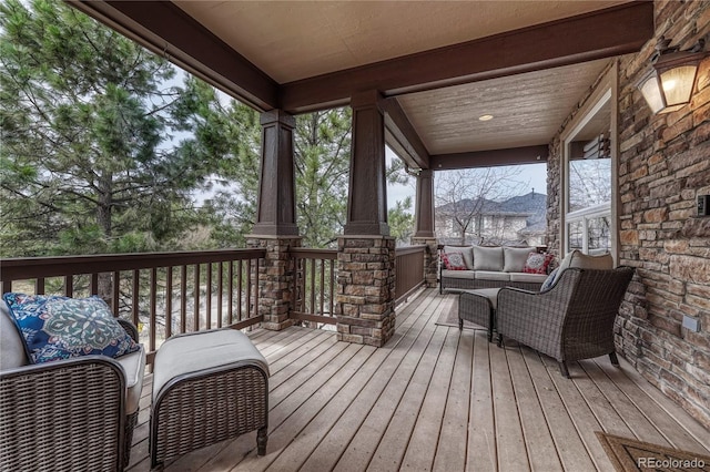 wooden terrace featuring outdoor lounge area