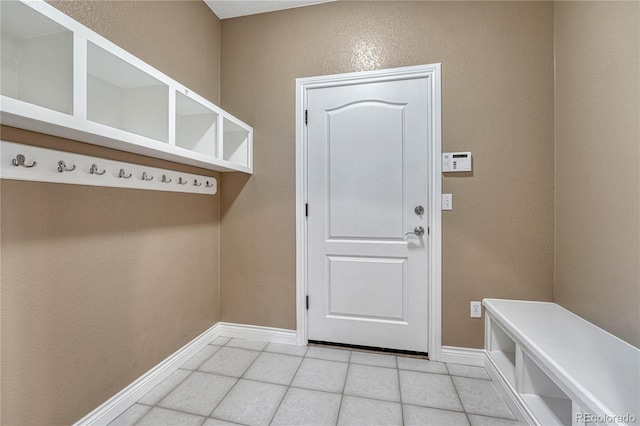 mudroom featuring baseboards and light tile patterned floors