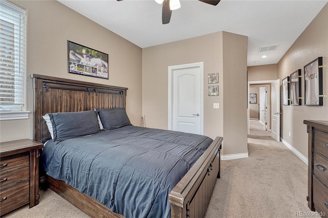 bedroom featuring a ceiling fan, baseboards, light colored carpet, and visible vents