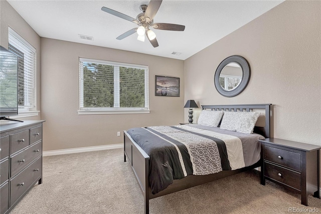 carpeted bedroom featuring baseboards, visible vents, and a ceiling fan