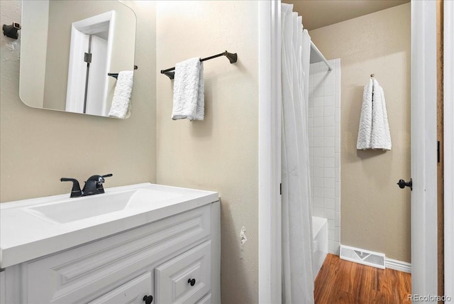 4351 S Evanston Ct, Aurora, CO 80015 - full bathroom featuring wood finished floors, vanity, and shower / bathtub combination with curtain