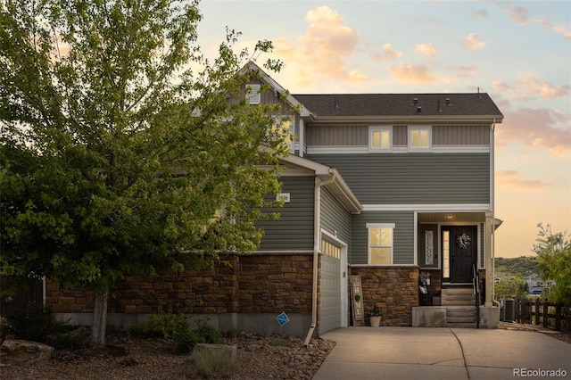 3871 Starry Night Loop, Castle Rock, CO 80109 - view of front facade with stone siding, driveway, and a garage